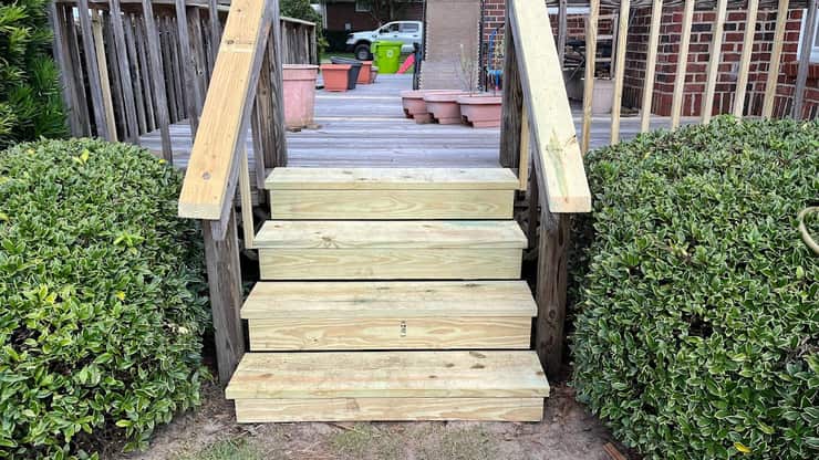 Rebuilt pressure-treated deck steps with new stringers and handrails