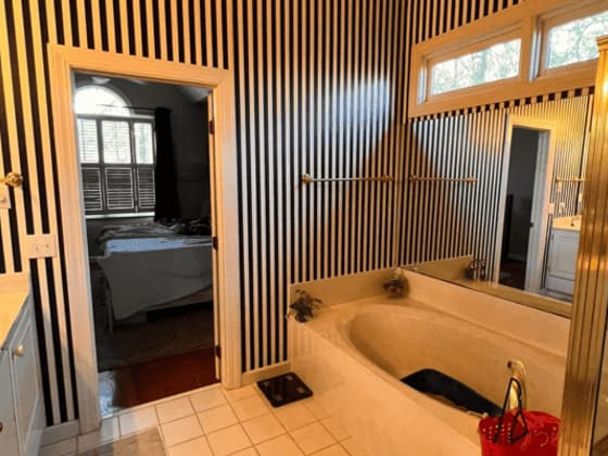 Corrugated metal accent wall built behind a garden tub in a bathroom under renovation