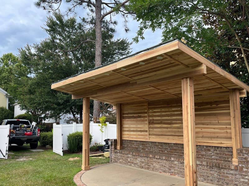 New open-sided timber carport built over a brick paver pad