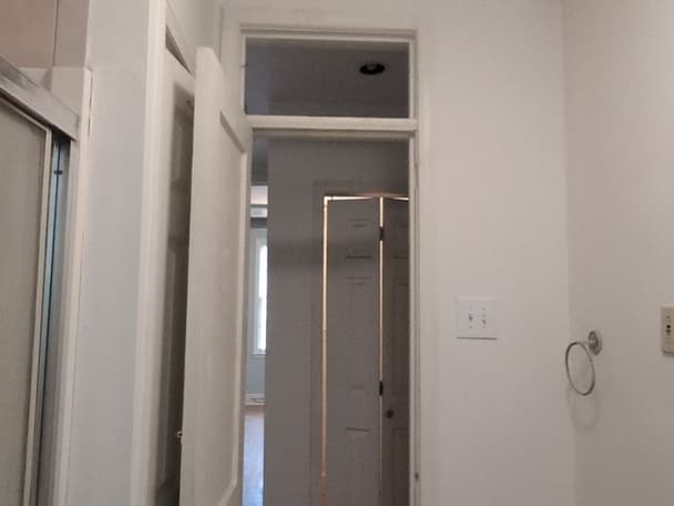 Hallway with new white doors and matching trim